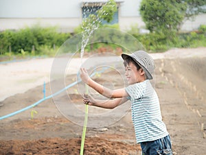 Little boy working planting in the farm outdoor