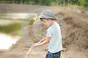 Little boy working planting in the farm outdoor