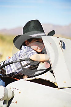 Little boy working on a tractor