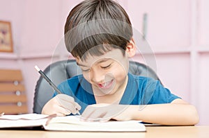 Little boy writing and thinking homework