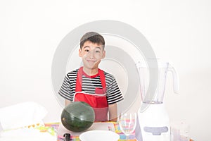 Little boys blend water melon juice by using blender