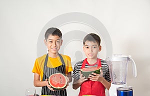 Little boys blend water melone juice by using blender home