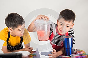 Little boys blend water melone juice by using blender home