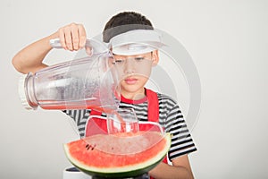 Little boys blend water melone juice by using blender home