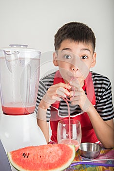 Little boys blend water melone juice by using blender home