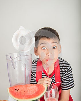 Little boys blend water melone juice by using blender home