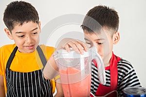 Little boys blend water melone juice by using blender home photo