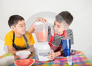 Little boys blend water melone juice by using blender home photo