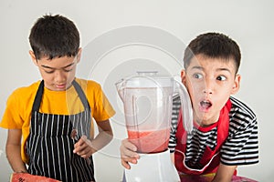 Little boys blend water melone juice by using blender home photo