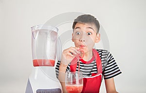 Little boys blend water melone juice by using blender home photo