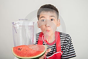 Little boys blend water melone juice by using blender home photo