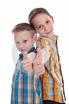Little boys - brothers - isolated with thumbs up.