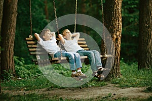 Little boys dreaming on swing