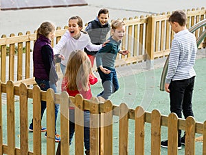 Little boys and girls playing Touch-last