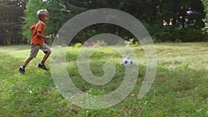 Little boys playing american soccer outdoors