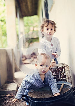 Little boys playing outside the house