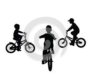 Little boys riding bicycle vector silhouette illustration isolated. Kids enjoy in ride bike.