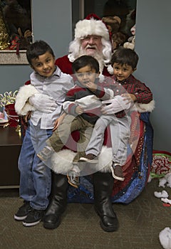 Little boys sit on Santa's lap at Christmas dinner for US Soldiers at Wounded Warrior Center, Camp Pendleton, North of San Diego,