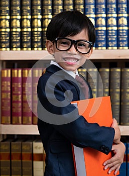 Little boys in suit looking and choose book