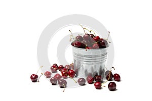 Little brass bucket of cherries isolated on white