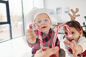 Little brother with her daughter celebrates New year and christmas at home