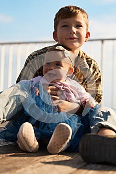 Little brother with his baby sister. Toddler kid Family with children outdoor.