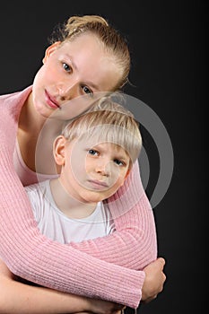 Little brother and sister embrace