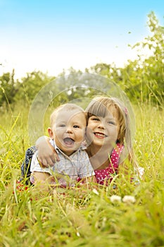 Little brother and sister playing on the nature