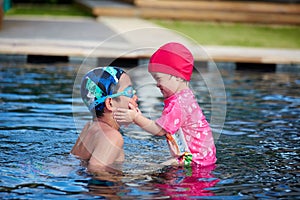 Little Brother and sistor intimate moment in pool