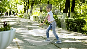 Little brunette girl doing somersault upheaval gymnastics in the park