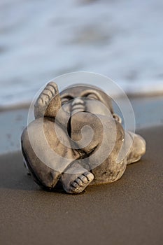 Little buddha statue on the beach