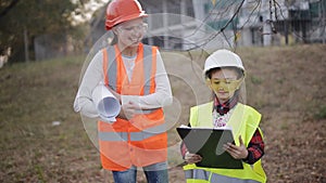 Little builders. Two child protective helmets and vests study technical documentation