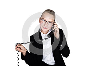 Little business woman talking on a phone, screaming into the phone. Studio portrait of child girl in business style