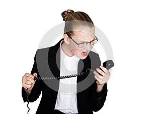 Little business woman talking on a phone, screaming into the phone. Studio portrait of child girl in business style