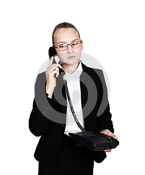 Little business woman talking on a phone, screaming into the phone. Studio portrait of child girl in business style
