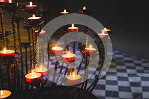 Little candles candlestick spiritism dark background photo