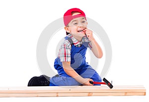 Little carpenter hit his finger while nailing photo