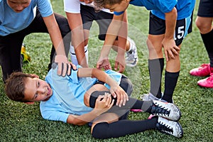 Little caucasian boy fell to his knee, ache in joints