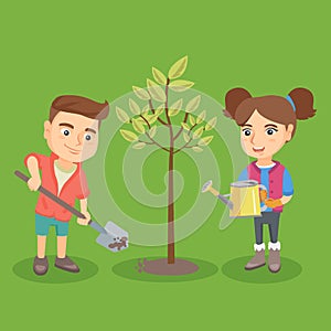 Little caucasian boy and girl planting the tree.