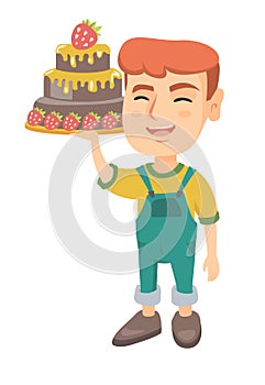 Little caucasian boy holding a chocolate cake.