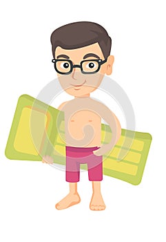 Little caucasian boy holding inflatable mattress.