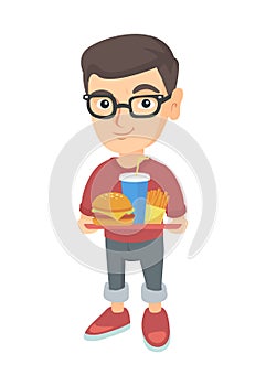 Little caucasian boy holding tray with fast food.