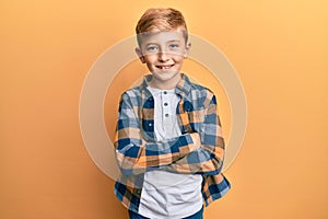 Little caucasian boy kid wearing casual clothes happy face smiling with crossed arms looking at the camera