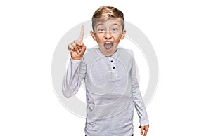 Little caucasian boy kid wearing casual clothes pointing finger up with successful idea