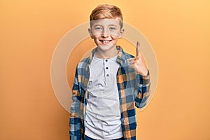 Little caucasian boy kid wearing casual clothes pointing finger up with successful idea