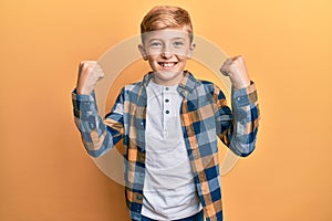 Little caucasian boy kid wearing casual clothes screaming proud, celebrating victory and success very excited with raised arms