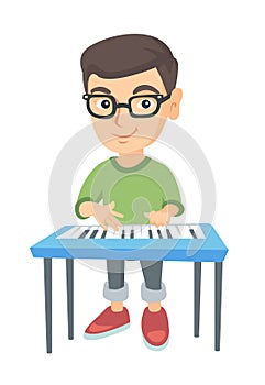 Little caucasian boy playing the piano.