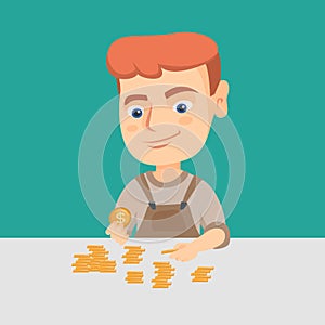 Caucasian boy counting coins on the table. photo