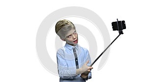 Little caucasian boy using selfie stick.