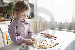 Little Caucasian girl baking in the kitchen , casual lifestyle